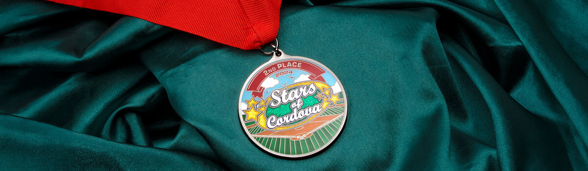 Stars of Cordova 2024 second place medal on a red ribbon resting on green satin