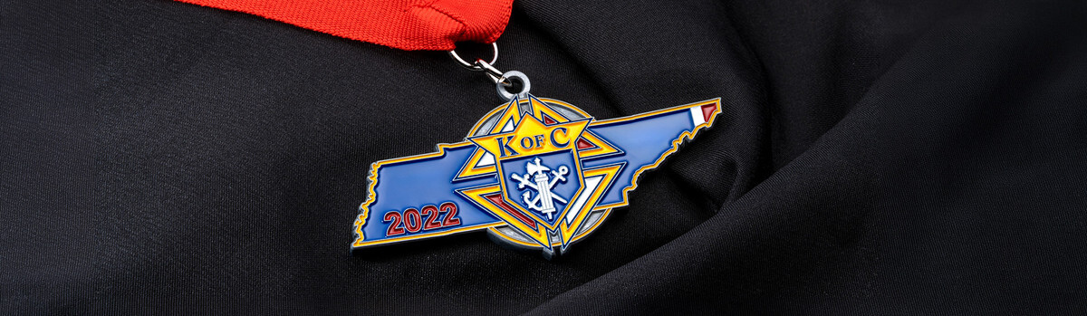 Knights of Columbus 2022 medal cut to the shape of the state of Tennessee on a red ribbon