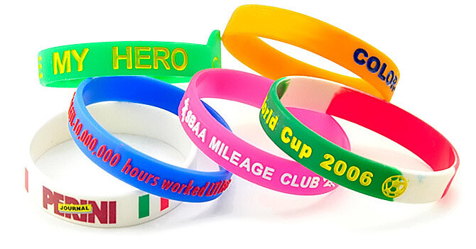Colorful custom silicone wristbands with printed messages in green, orange, blue, pink, and white