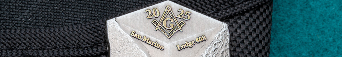 Antique silver Masonic die struck pin with a gold square and compass for San Marino Lodge 408, clipped to a black case
