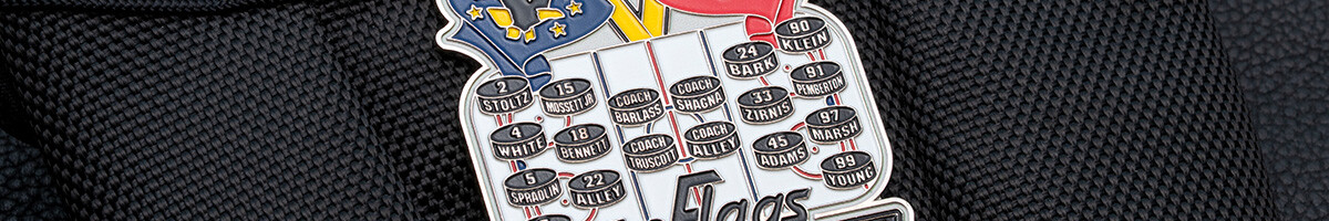 Detail of a Bantam A team pin listing each player's number and last name on individual pucks
