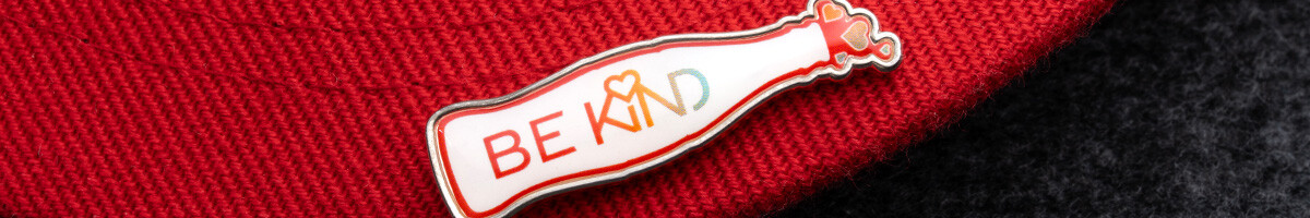 Be Kind soda bottle offset printed pin on the brim of a red cap