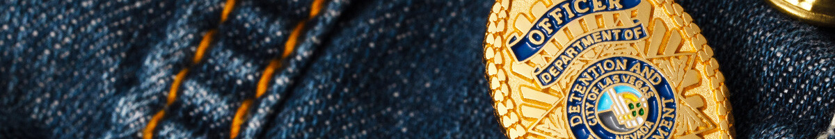 Gold Las Vegas Department of Detention and Enforcement officer badge pin on denim