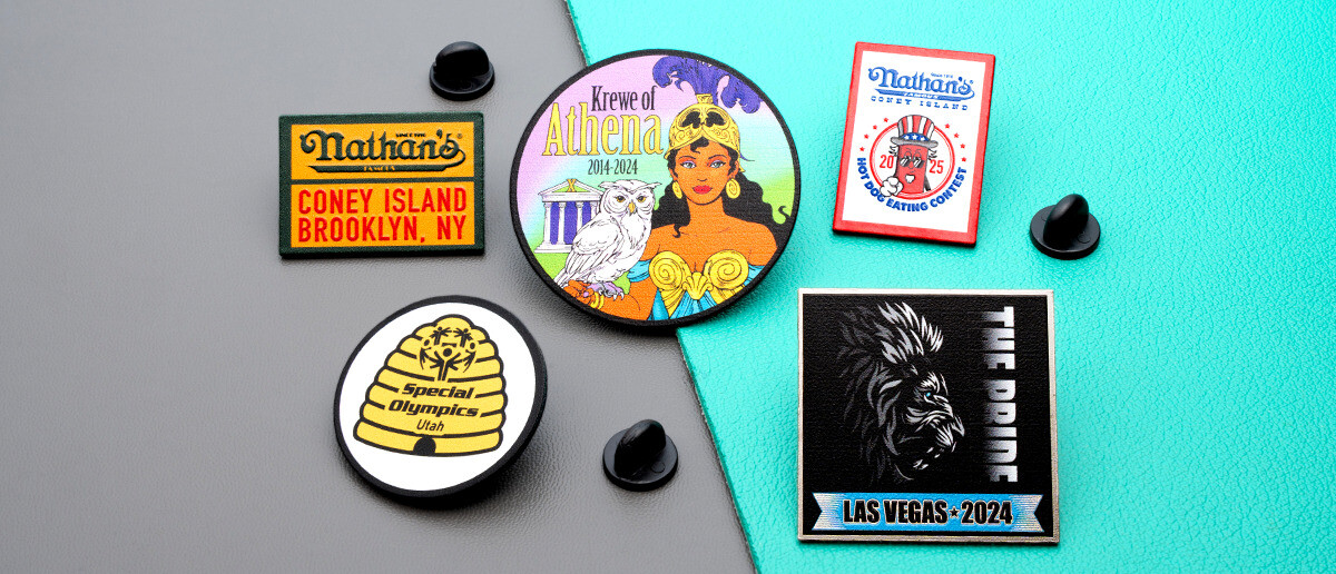 Collection of full-color printed rush lapel pins including Nathan's Famous Coney Island, Krewe of Athena, Special Olympics Utah, and The Pride Las Vegas designs